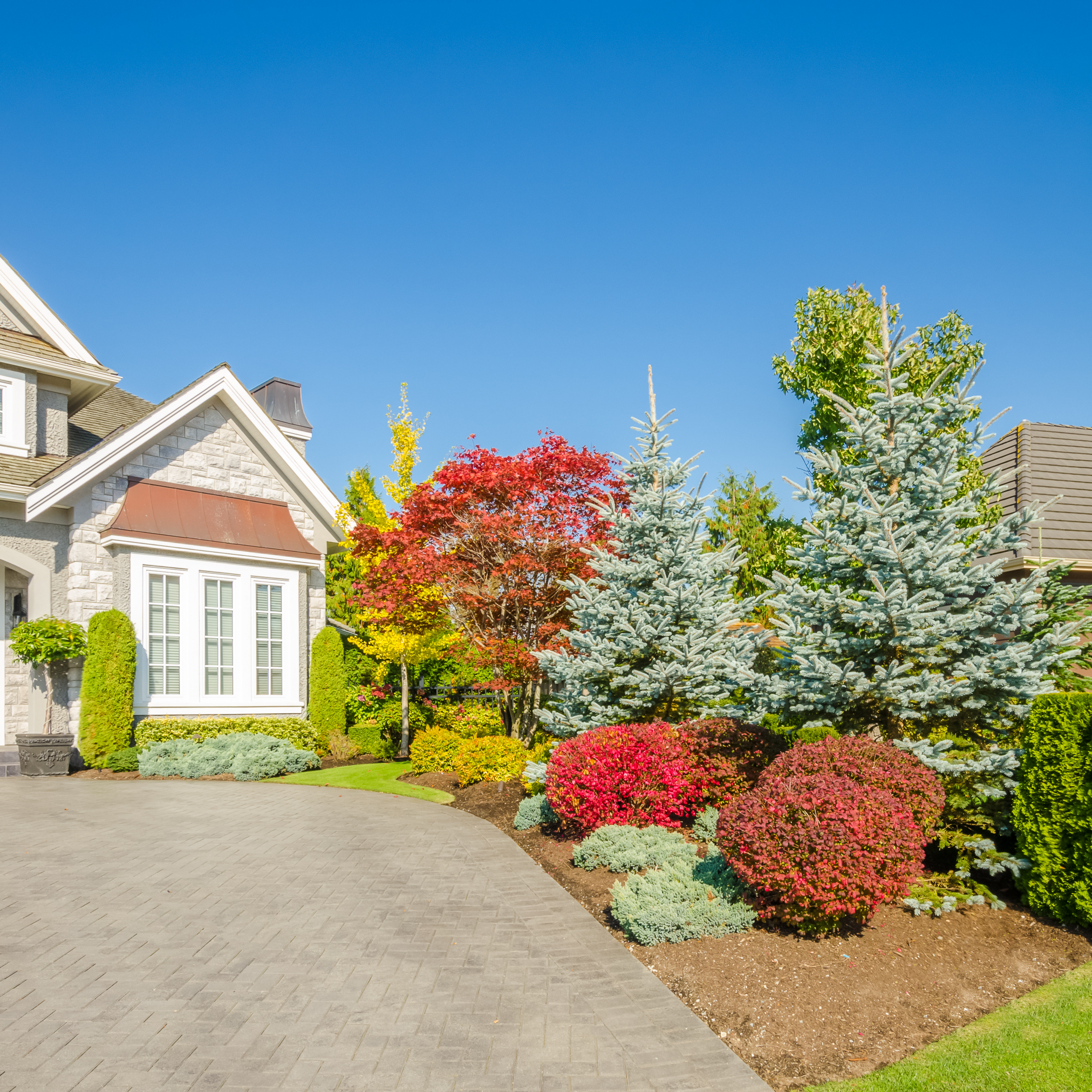 luxury house with beautiful flower garden landscape beside driveway